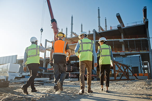 Construction workers walk together on a job site