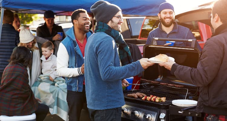 An alumni group tailgates before a football game